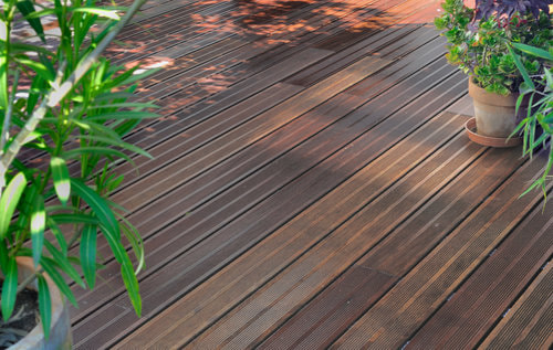 A picture of a wooden deck with flowers.